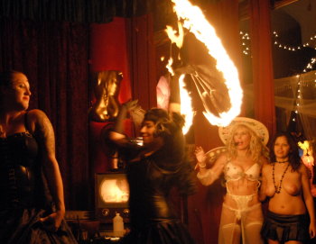 Fire Dancers Raiden and Jenai perform at Dr. Suzys Speakeasy (while Evie Delatosso and I are blown away in the background) .