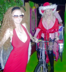  Bicycling the rickshaw filled with gifts for naughty people, led by red-haired reindeer Annie Body. Photo: Kim 