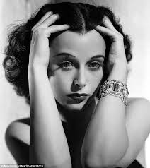 Brainy Beauty Hedi Lamarr runs her fingers through her hair.