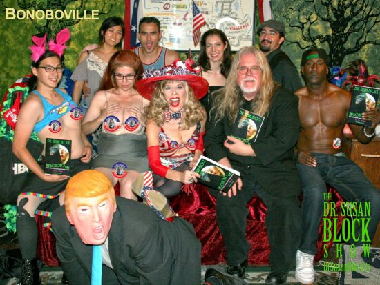 Trump on his knees, spanked by The Bonobo Way, flanked by U.S. Presidential Candidates Mistress Tara & Mr. Vallance on DrSuzy.Tv. Photo: L'Erotique