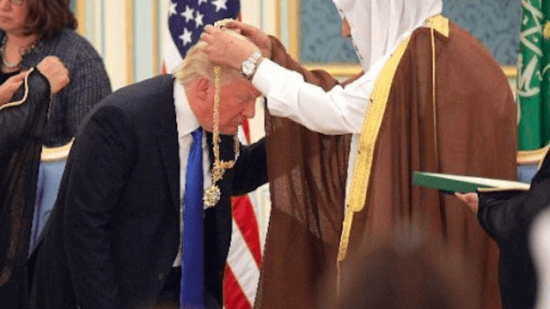 Golden-Showers Trump curtsies to receive a gaudy Saudi gold medal for being a U.S. Presidential Douchbag. 
