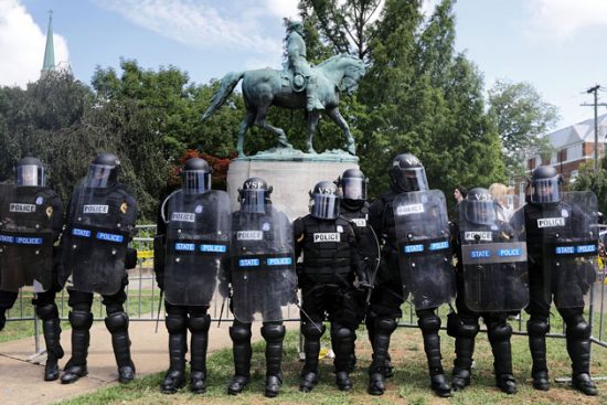 Charelottesville Police dressed as Robocops protect each other and the statue of Robert E. Lee.