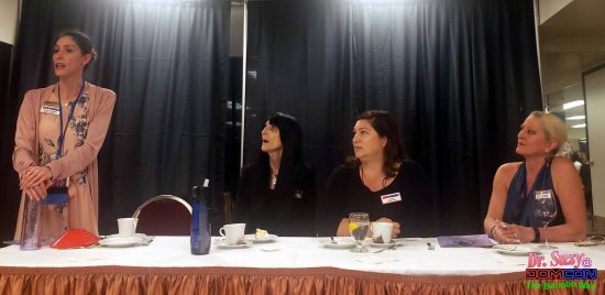 Madame Margherite address the Dommes of DomCon 2019, flanked by Mistress Cyan, Genesis and Mistress Precious. 