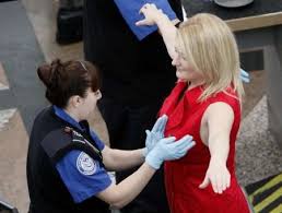 TSA "female" agent cecking for boobs--I mean bombs.