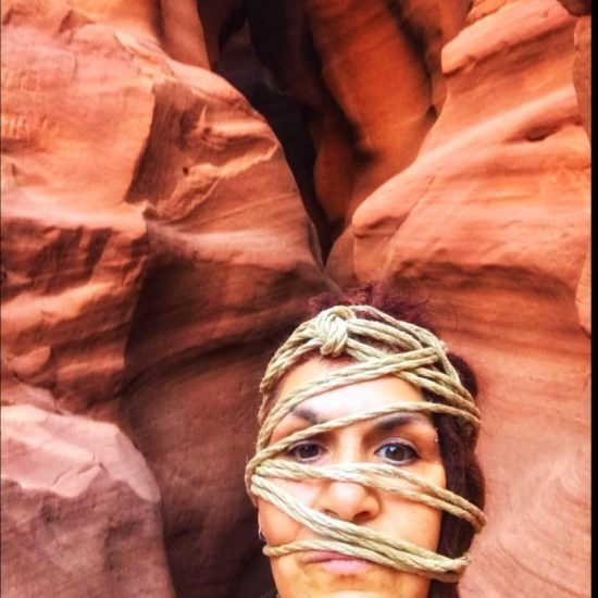 Ishara ties up her own face in the Antelope Canyon