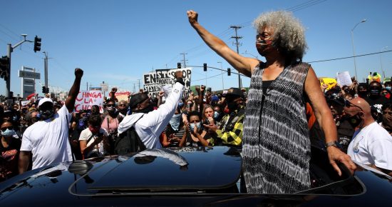 Angela Davis pumps her fist at the 2020 Juneteenth BLM rally in Oakland.